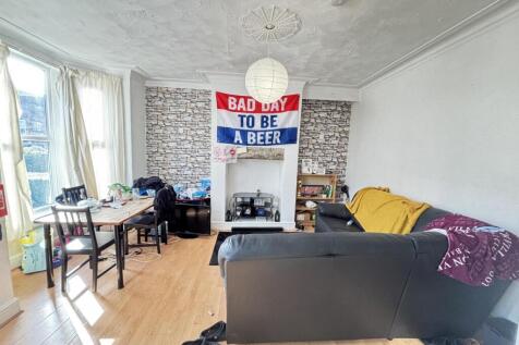 Bright and stylish living room featuring a comf...