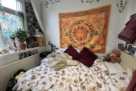 A cozy master bedroom featuring a large bed wit...