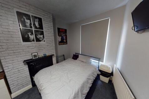 A comfortable double bedroom featuring a cozy b...