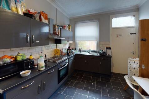 A functional and well-lit kitchen area featurin...
