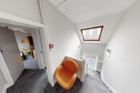 A compact, tidy room featuring a single toilet ...