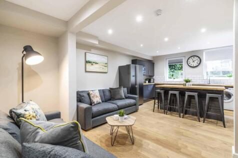 A modern, spacious living room with ample seati...