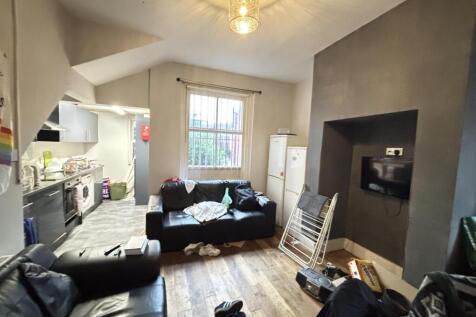 A cozy and well-lit living room with a large wi...