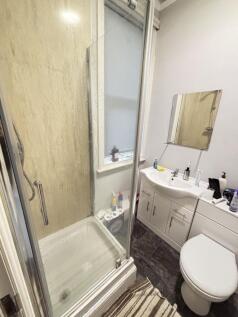 A well-maintained bathroom featuring a shower e...