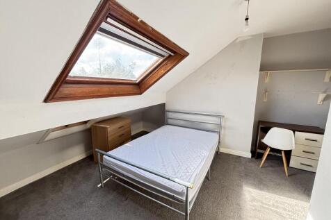 A well-maintained bedroom with a comfortable si...