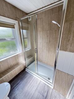 Bright and clean bathroom featuring a spacious ...