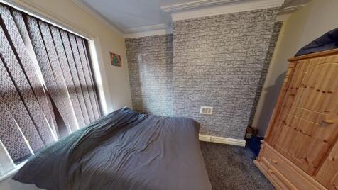 A well-maintained bedroom featuring a comfortab...