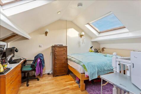 A charming double bedroom featuring a comfortab...