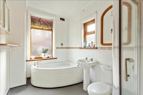 This elegant bathroom suite features a spacious...