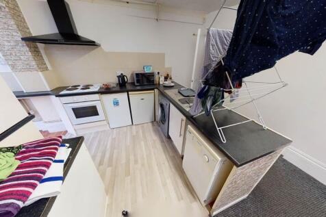 A modern kitchen area with a compact layout, fe...