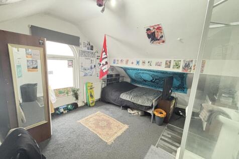 A well-lit, comfortable living room featuring a...