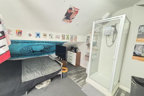 A well-maintained bathroom featuring a shower c...