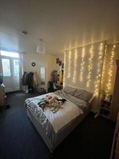 A cozy bedroom featuring a comfortable bed with...