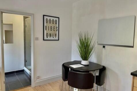 Bright kitchenette/dining nook with a round bla...