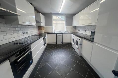 Modern galley kitchen with glossy white cabinet...
