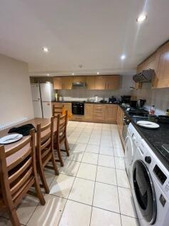 Bright, well-equipped communal kitchen with ple...