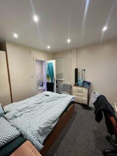 Furnished double bedroom with a double bed, bui...