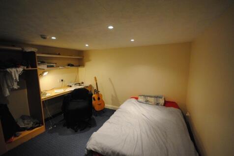 Cozy furnished bedroom with a single bed, built...