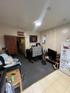 Bright communal living room with modern ceiling...