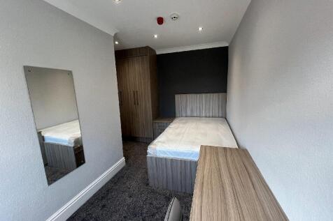 A neatly maintained single bedroom featuring a ...