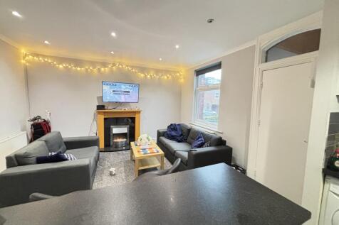 A bright and spacious living room featuring con...