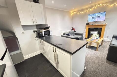 A modern and cozy living room featuring comfort...