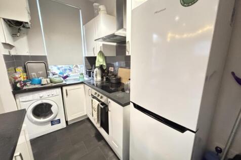 A well-organized modern kitchen with various ap...