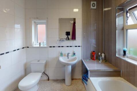 Bright and clean bathroom featuring a large sin...