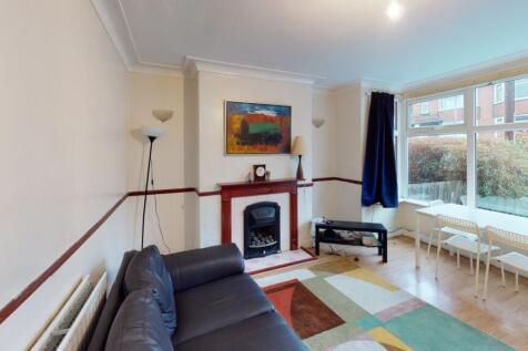 A bright and welcoming living room with large w...