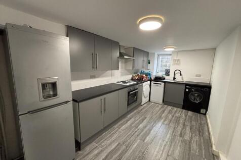 Modern galley-style kitchen with grey fitted un...