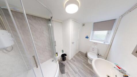 A spacious and modern bathroom featuring a larg...
