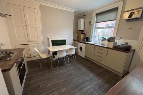 A modern and tidy kitchen area with ample natur...