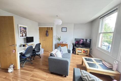 A bright and inviting living room with ample na...