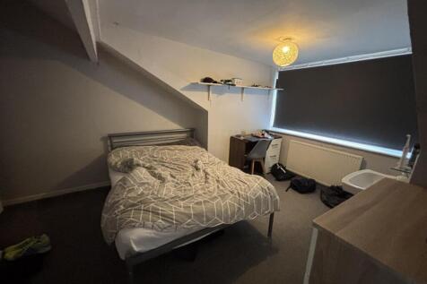 A cozy bedroom with a double bed positioned und...