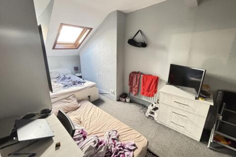 A spacious, well-lit contemporary living room w...