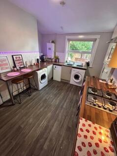 A bright and tidy kitchen with ample natural li...