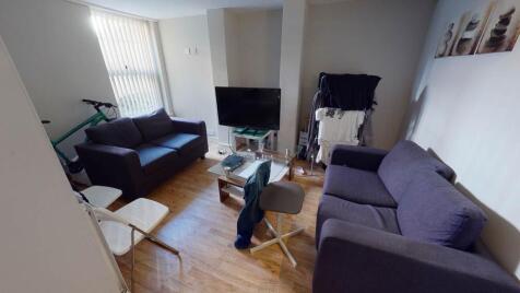 A spacious and modern living room illuminated b...