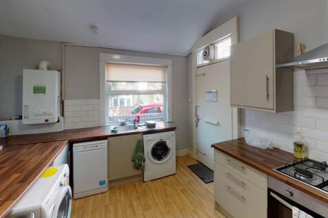 A bright and tidy kitchen with ample natural li...
