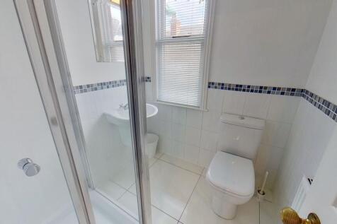 Bright, modern bathroom with white tiles, a wal...