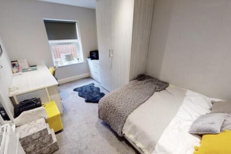 A cozy, well-maintained bedroom featuring a lar...