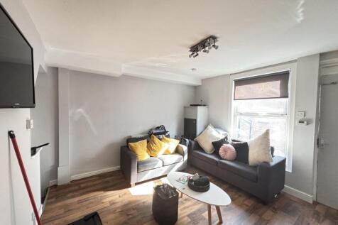 Bright and inviting living room with ample natu...