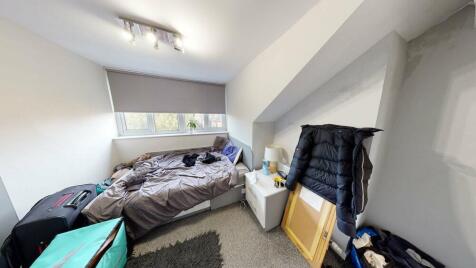 A compact but bright bedroom featuring a single...