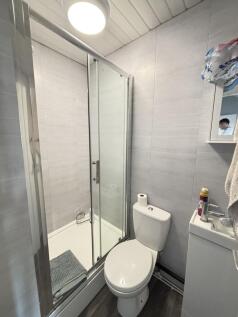 A clean and functional bathroom featuring a sho...