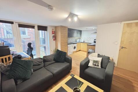 A spacious and welcoming living room featuring ...