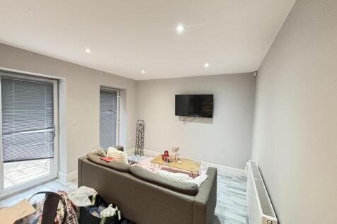 A modern, well-lit living room featuring a comf...