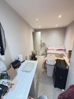 A spacious master bedroom featuring a comfortab...