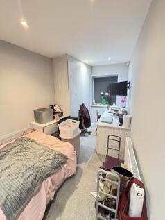 A well-lit and tidy bedroom featuring a promine...