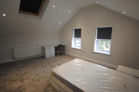 Bright and spacious bedroom with large windows ...