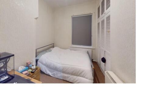 A cozy and well-maintained bedroom featuring a ...