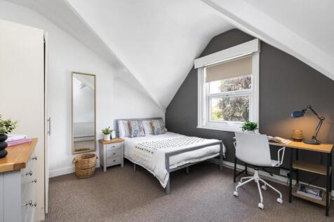 A bright and spacious master bedroom featuring ...